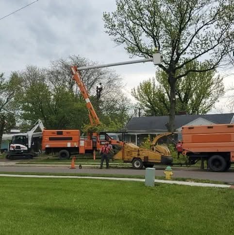 Martins Tree Service crew with crane truck and chipper on a residential job